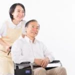 車椅子の高齢者を介護するサービス提供責任者の女性スタッフ